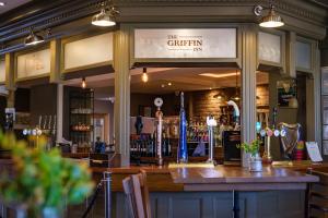 a bar in a pub with a sign that reads the kitchen at The Griffin Inn in Saint Helens
