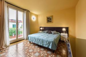 a bedroom with a bed and a large window at B&B Casa Rossa in Florence