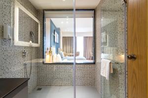 a bathroom with a shower with a glass door at Dayal Gateway in Lucknow