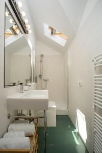 a white bathroom with a sink and a mirror at Apartment St.Jacob in Dubrovnik