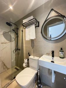 a bathroom with a toilet and a sink and a mirror at Chic Apart Spacieuse & Lumineuse in Tangier +16 photos