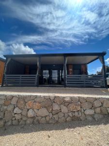 a building with a stone wall in front of it at Mobile Home L&L in Drage