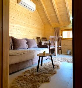 a living room with a couch and a table at Wooden Corner in Kolašin