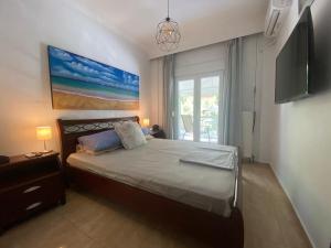 a bedroom with a large bed and a window at Norra Apartments in Thessaloniki