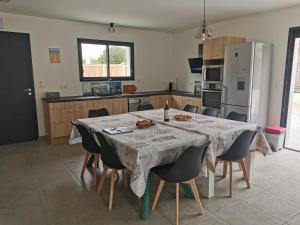 a kitchen with a table and some food on it at Maison familiale Andernos in Andernos-les-Bains