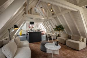 a living room with two couches and a table at The Lemon Suites in Deventer