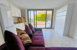 a living room with a purple couch with pillows at Single Room at Adabuku Seba Solemar Holiday Site -Luxury Beach Utilities Included in Bogazici