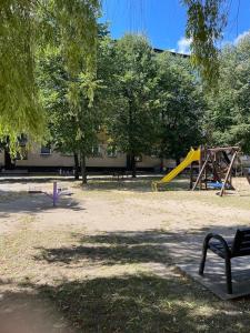 a park with a playground with a slide and trees at Apartament Kasztanowa in Augustów