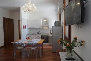 een keuken met een tafel met stoelen en een koelkast bij Campo San Lorenzo in Venetië