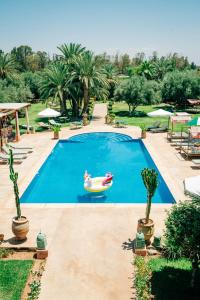 a swimming pool with a rubber duck in a paddler at La Villa Des Golfs & PinkCactus in Marrakesh