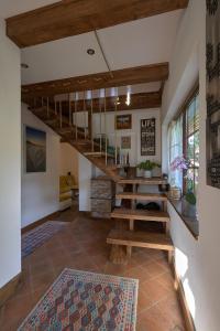 a living room with a staircase and a table at Walnut Tree Cottage in Săcele