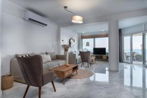 a living room with a couch and a table at Porto Lygia Apartment in Ierapetra