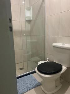 a bathroom with a toilet with a black lid at Hostel Morro de Sao Paulo in Salvador