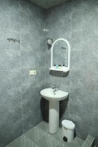 a bathroom with a sink and a toilet at h’Olarooms N3 in Tʼianetʼi