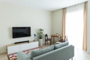 a living room with a couch and a tv at ММ GROUP APARTMENT in Uzhhorod