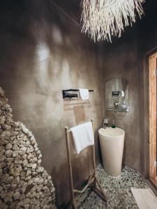 a bathroom with a sink and a mirror at Hillstone U Villa in Uluwatu