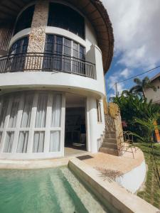 a house with a swimming pool in front of it at Hillstone U Villa in Uluwatu