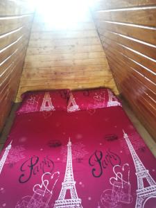 a bed with the words paris and the eiffel tower on it at Cabana Ema in Curtea de Argeş