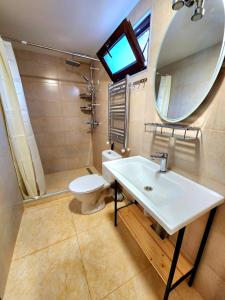 a bathroom with a sink and a toilet and a mirror at House&Yard Hellen 150m to beach in Ureki