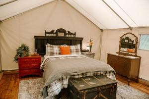 a bedroom with a bed in a tent at Station Chene rouge in Albert Mines