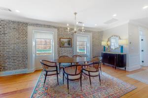 a dining room with a table and chairs at Rainbow Row Pied-A-Terre in Charleston