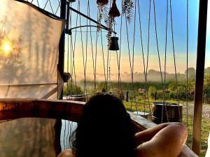 a person is sitting on a ride in a swing at Stablo guest house in Bărăşti