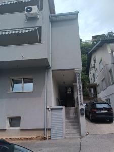 a house with a car parked in front of it at Guesthouse Hortenzija in Mostar