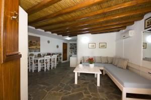 a living room with a couch and a table at Sourmeli Garden Hotel in Mikonos