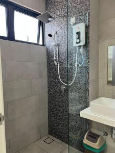 a bathroom with a shower and a sink at The Seashore House, The Shore Kota Kinabalu in Kota Kinabalu