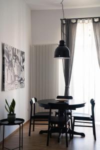 a dining room with a black table and chairs at Appartamento Vittoria in Bisceglie