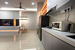 a kitchen with a counter top with a microwave at InStay Atlantis - The Orange in Melaka