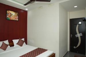 a bedroom with a bed and a painting on the wall at Redstone Hotel - Near US Consulate Nungambakkam in Chennai