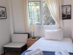 a bedroom with two beds and a window at Villa Aroma in Polychrono
