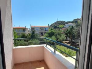 a balcony with a view of a city at Villa Aroma in Polychrono +37 photos