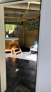 an open patio with a table and a chair at Sèid Bò - Sleeps 6 - NEW Private 6 Person HotTub Available in Burnfoot