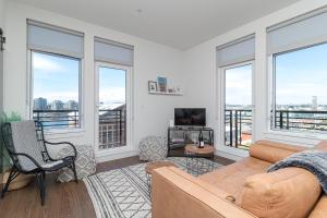 a living room with a couch and some windows at Ironworks Building Victoria in Victoria