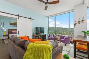 a living room with a couch and a table at 'Endless Sunset Retreat' A Luxury Downtown Condo with Panoramic Mountain Views at Arras Vacation Rentals in Asheville