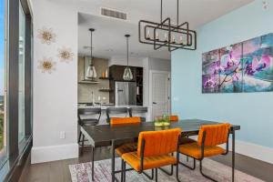 a kitchen and dining room with a table and chairs at 'Endless Sunset Retreat' A Luxury Downtown Condo with Panoramic Mountain Views at Arras Vacation Rentals in Asheville