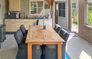 a wooden table and chairs in a kitchen at Cozy Home In Tiendeveen With Wifi in Tiendeveen