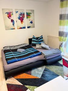 a bed sitting on top of a rug in a room at Ferienwohnung "Lilly" inklusive Nutzung W-Lan Bettwäsche und Handtücher in Annaberg-Buchholz