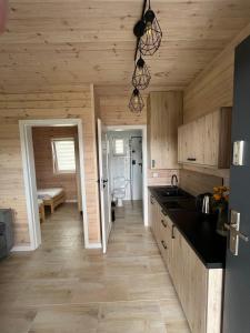 a kitchen with wooden walls and wooden flooring at Przystań Tolkmicko in Tolkmicko