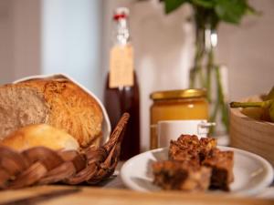 a table with a plate of bread and a basket of food at Hotel Baders Krone in Laupersdorf