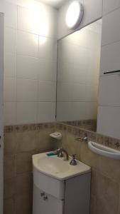 a bathroom with a sink and a mirror at Moreno1300/9 in Rosario