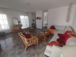 a living room with a couch and chairs and a table at Casa Ina in El Roque, El Cotillo in Roque