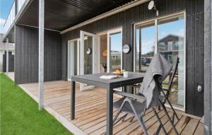a patio with a table and a chair on a deck at Stunning Apartment In Slagelse With Kitchen in Slagelse