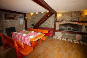 a dining room with a table and a fireplace at Kuća za odmor Krasnica in Novi Vinodolski