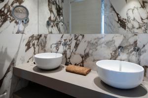 two white bowls on a counter in a bathroom at Residence Carl&Do in Baveno