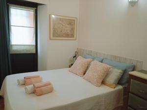 a bedroom with a bed with two pillows on it at La Maisonette in Sori