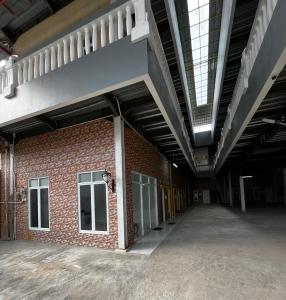 an empty hallway of a brick building with a skylight at Jo&Jo Hostel in Bandar Lampung