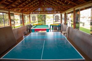 a ping pong table in a pavilion with two tables at Hotel Thermas Bonsucesso in Jataí